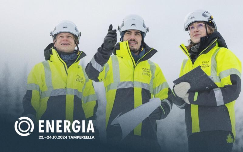 Three persons standing and wearing construction workwear.