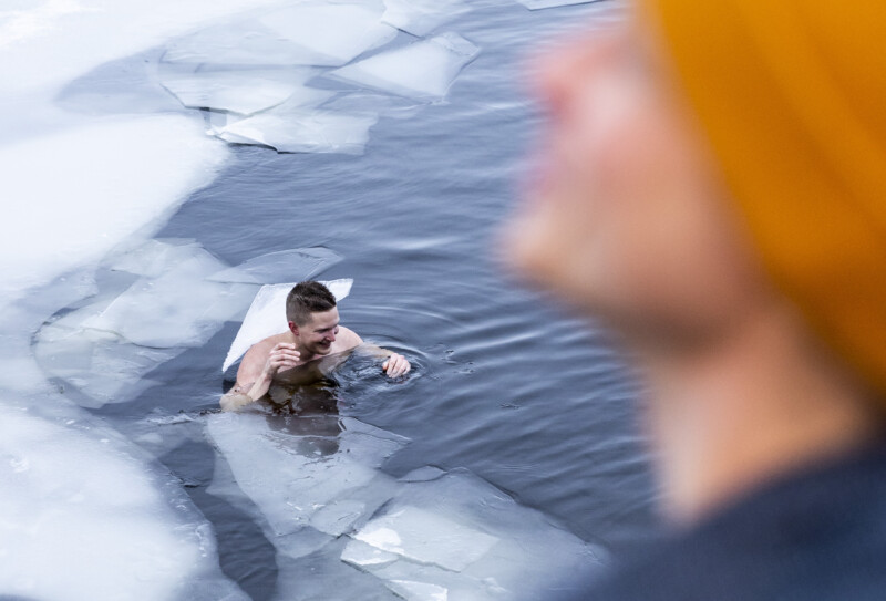 A person ice swimming with ice floats.